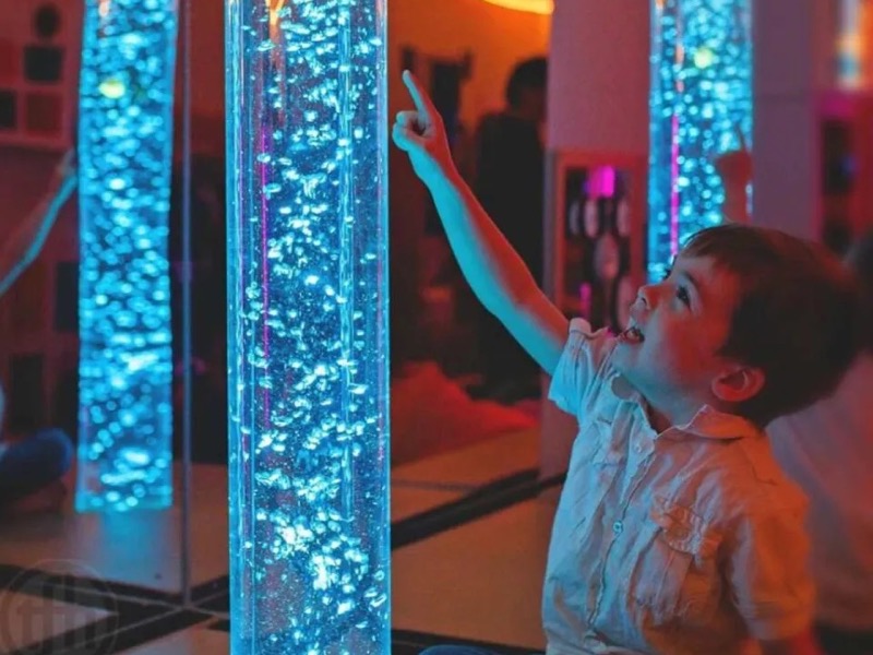 Glowing bubble tubes in a colourful sensory room